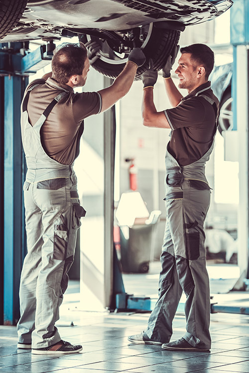 Mechanics under car at North East Auto Services