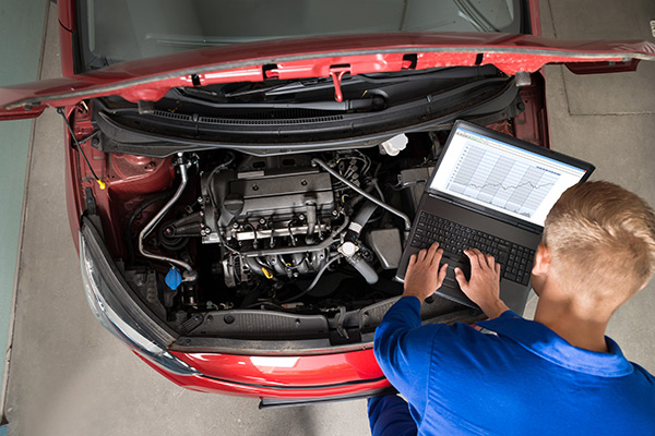 Mechanic running diagnostics on a car