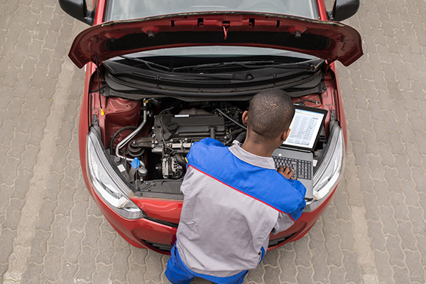 Mechanic running diagnostics on a car