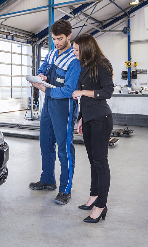 Mechanic giving customer a quote a breakdown of their MOT